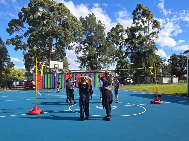 Students playing volleyball.
