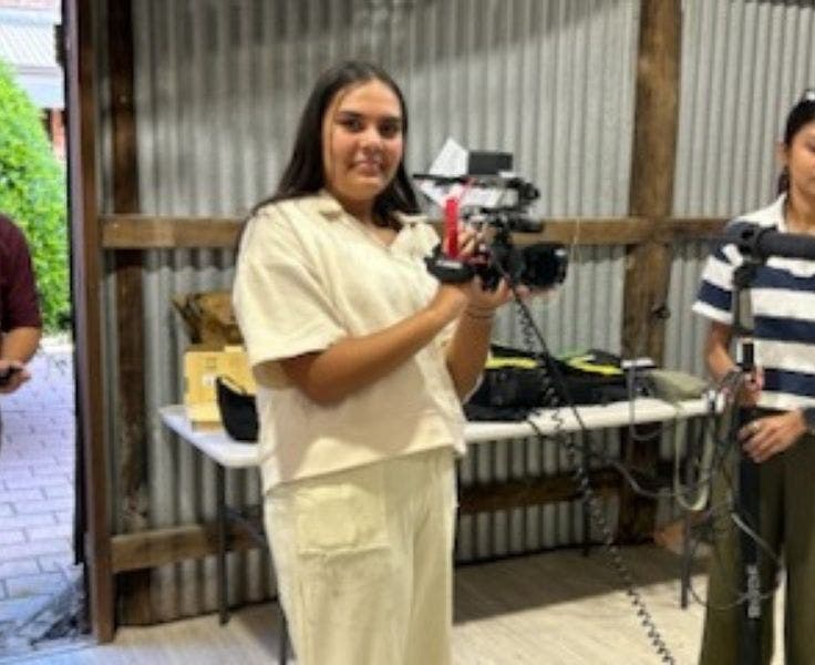 Student participating in a filming set.