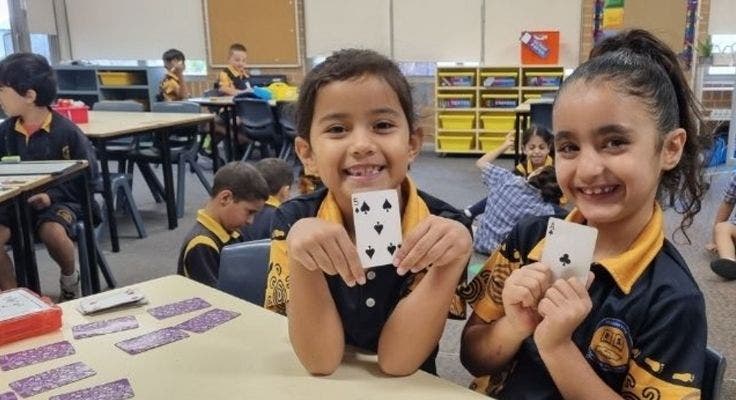 Students doing maths activities in classroom.