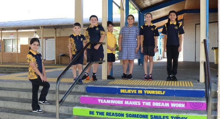 Students standing on steps near canteen.